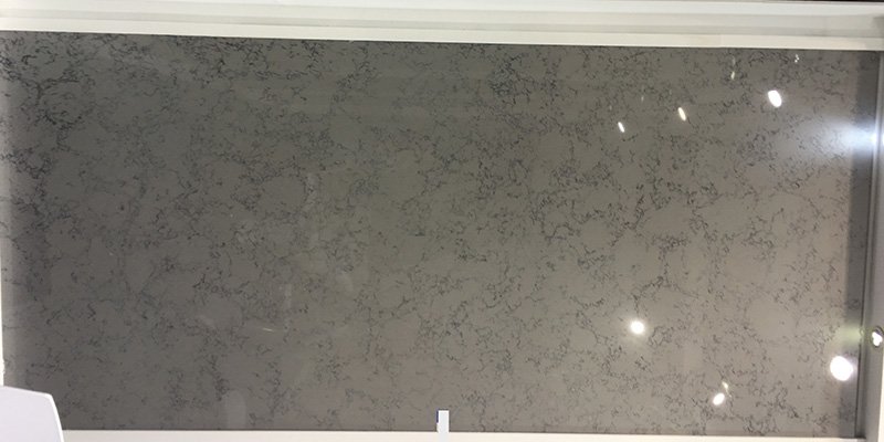 A close-up of a Carrara quartz slab showing its fine details and flawless polish.