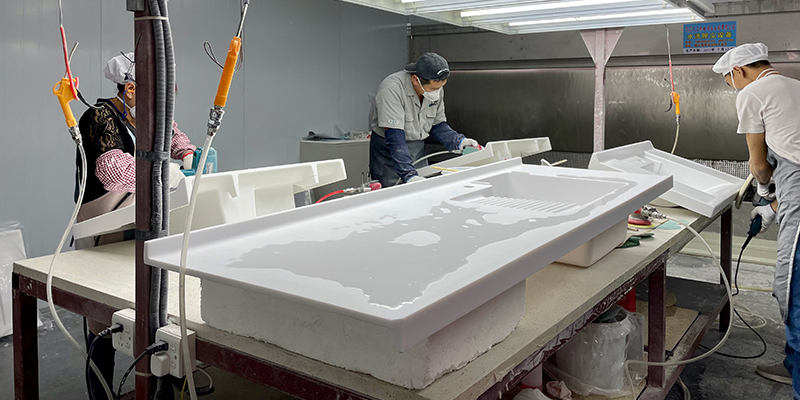 Cleaning a Solid Surface Basin A hand easily cleaning a solid surface sink